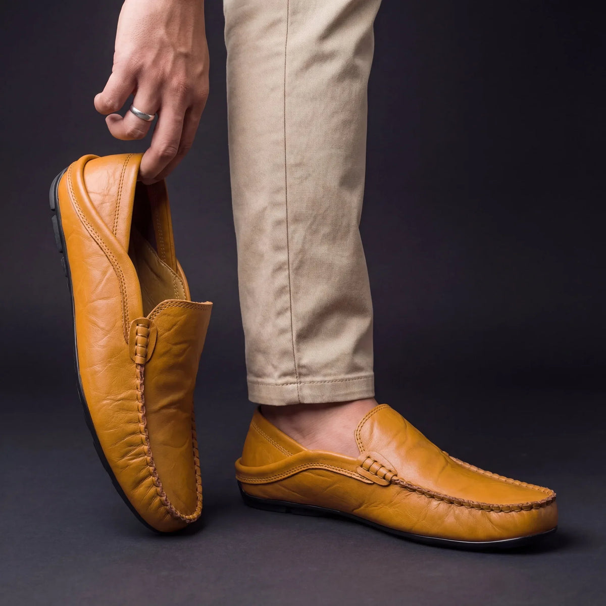 Slip-on moccasin shoes with stitched edging and rounded toes