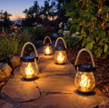 Black solar lantern with clear housing, flame effect and rope handle