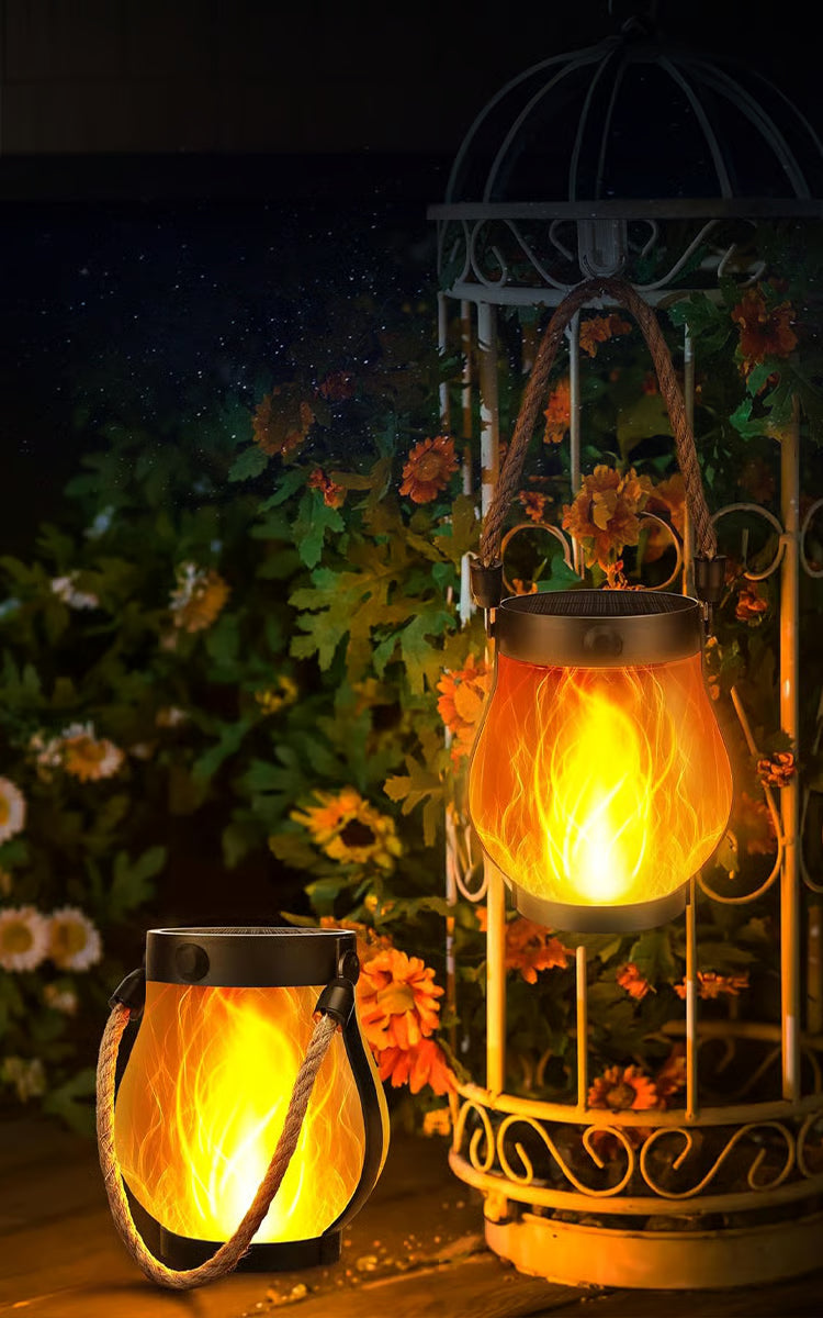 Black solar lantern with clear housing, flame effect and rope handle
