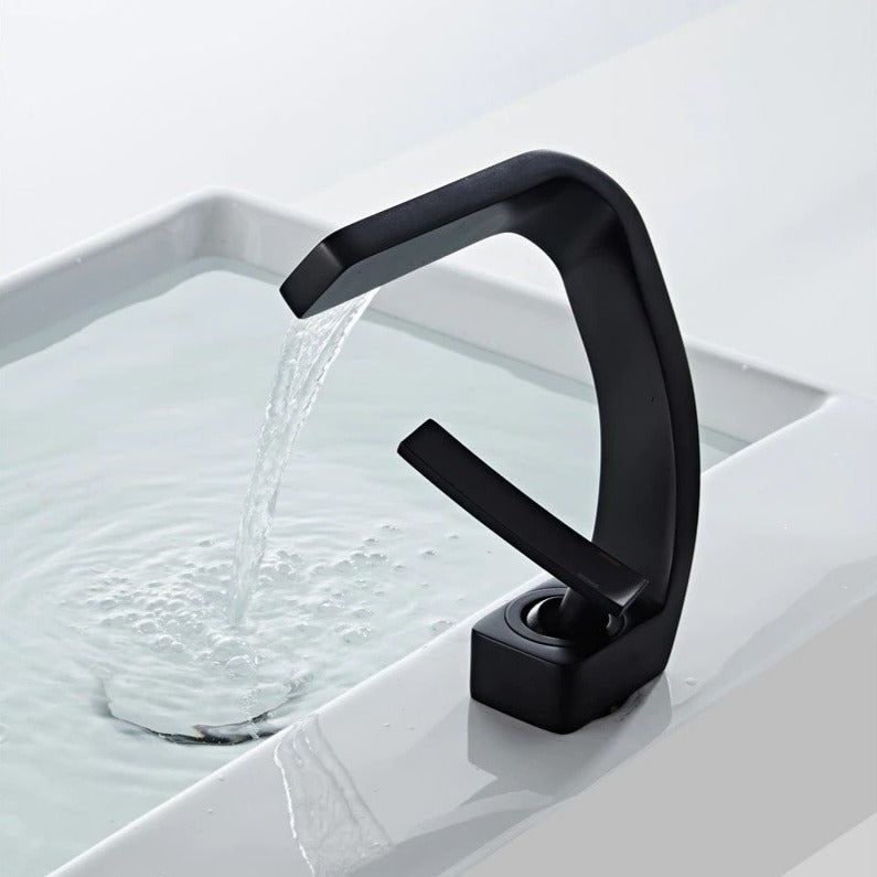 Curved bathroom basin faucet with waterfall-style spout and single lever
