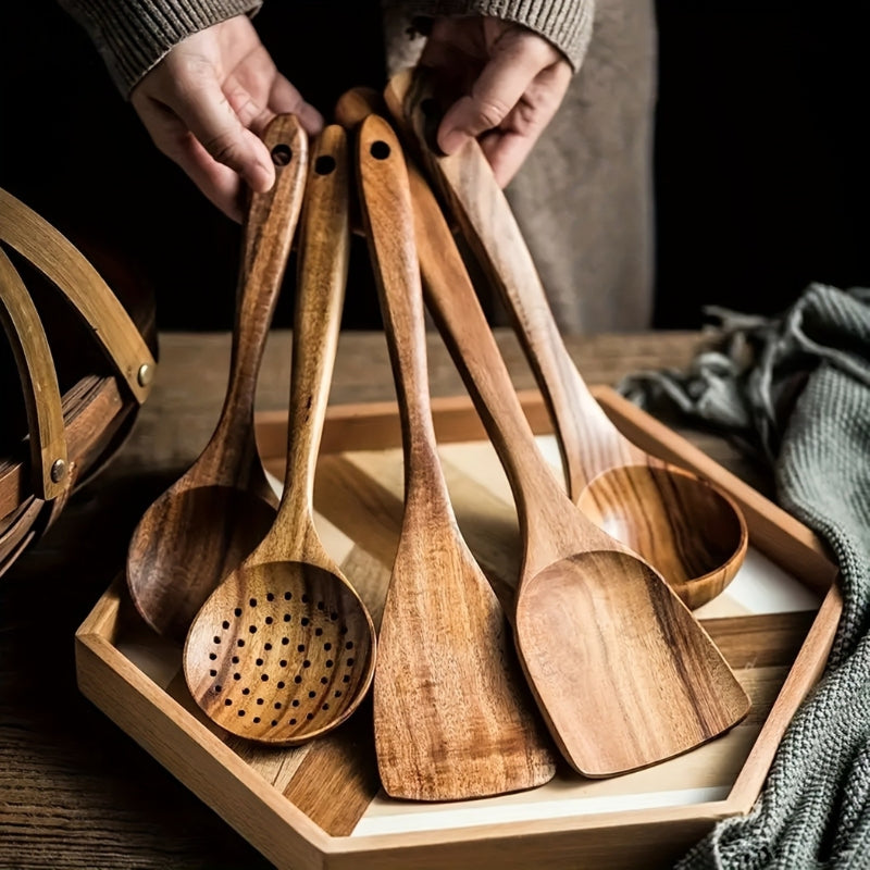 Five-piece brown wooden kitchen utensil set with spoons and spatulas