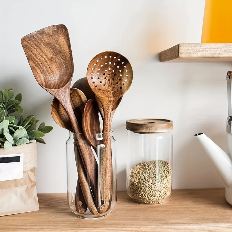 Five-piece brown wooden kitchen utensil set with spoons and spatulas