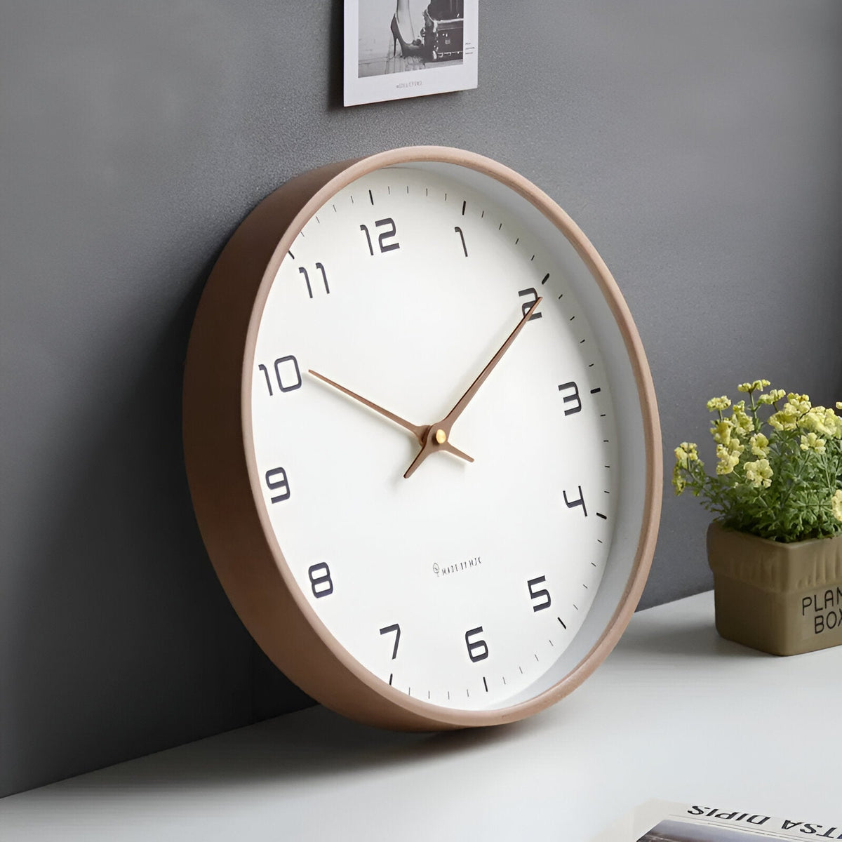 Round analogue wall clock with light dial and wood-effect frame