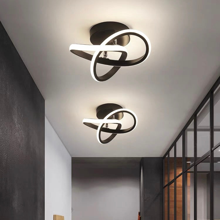 Set of two modern looping LED ceiling lights installed along a hallway