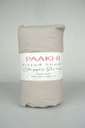 Rolled beige king size fitted sheet with packaging label