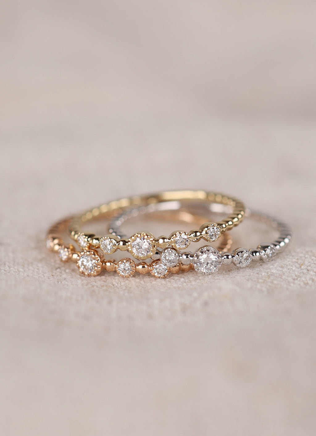 Yellow gold ring with beaded band and three diamond-set accents