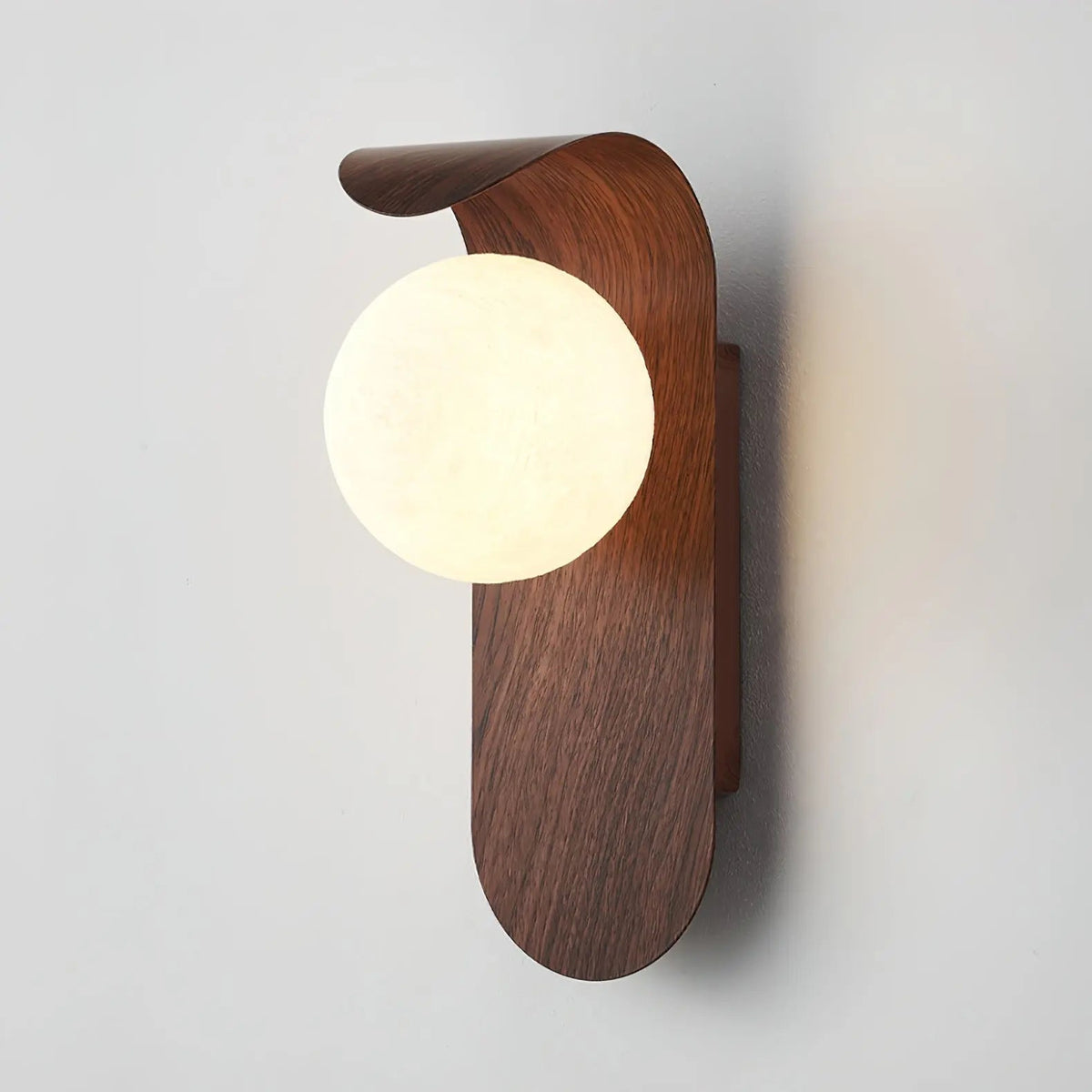 Japandi LED wall light with round globe shade and curved wood-effect panel