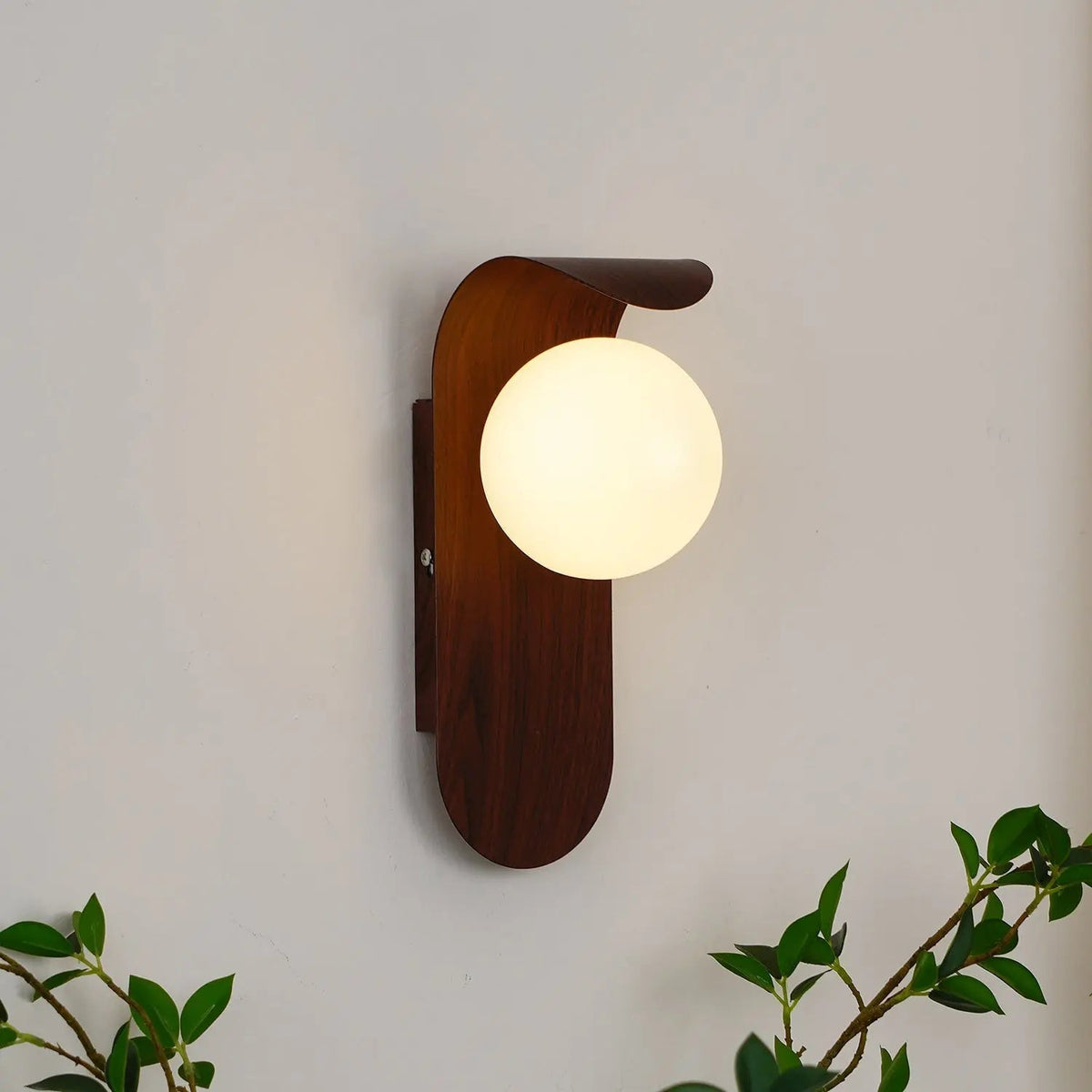 Japandi LED wall light with round globe shade and curved wood-effect panel