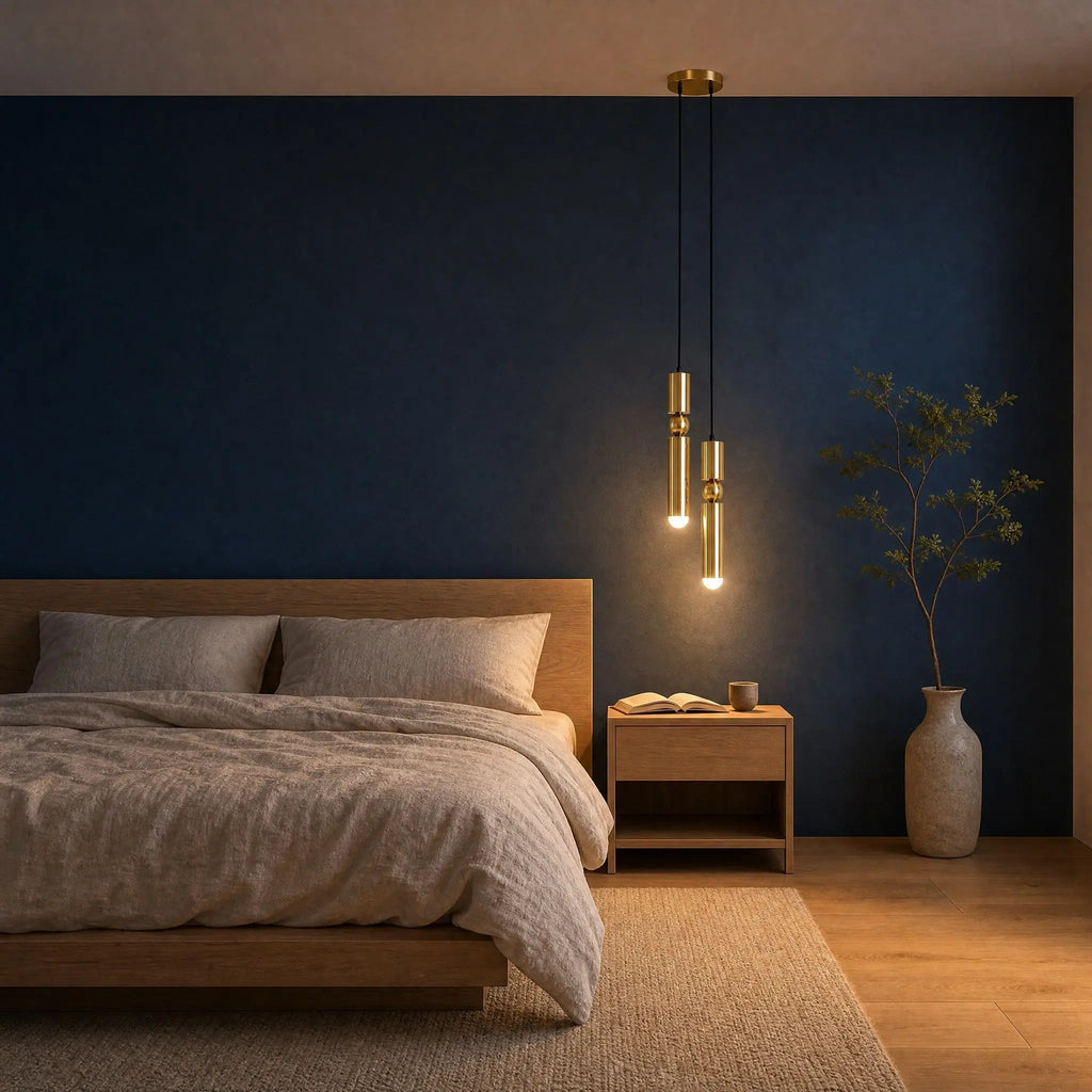 Gold pendant light with two cylindrical hanging elements and spherical details