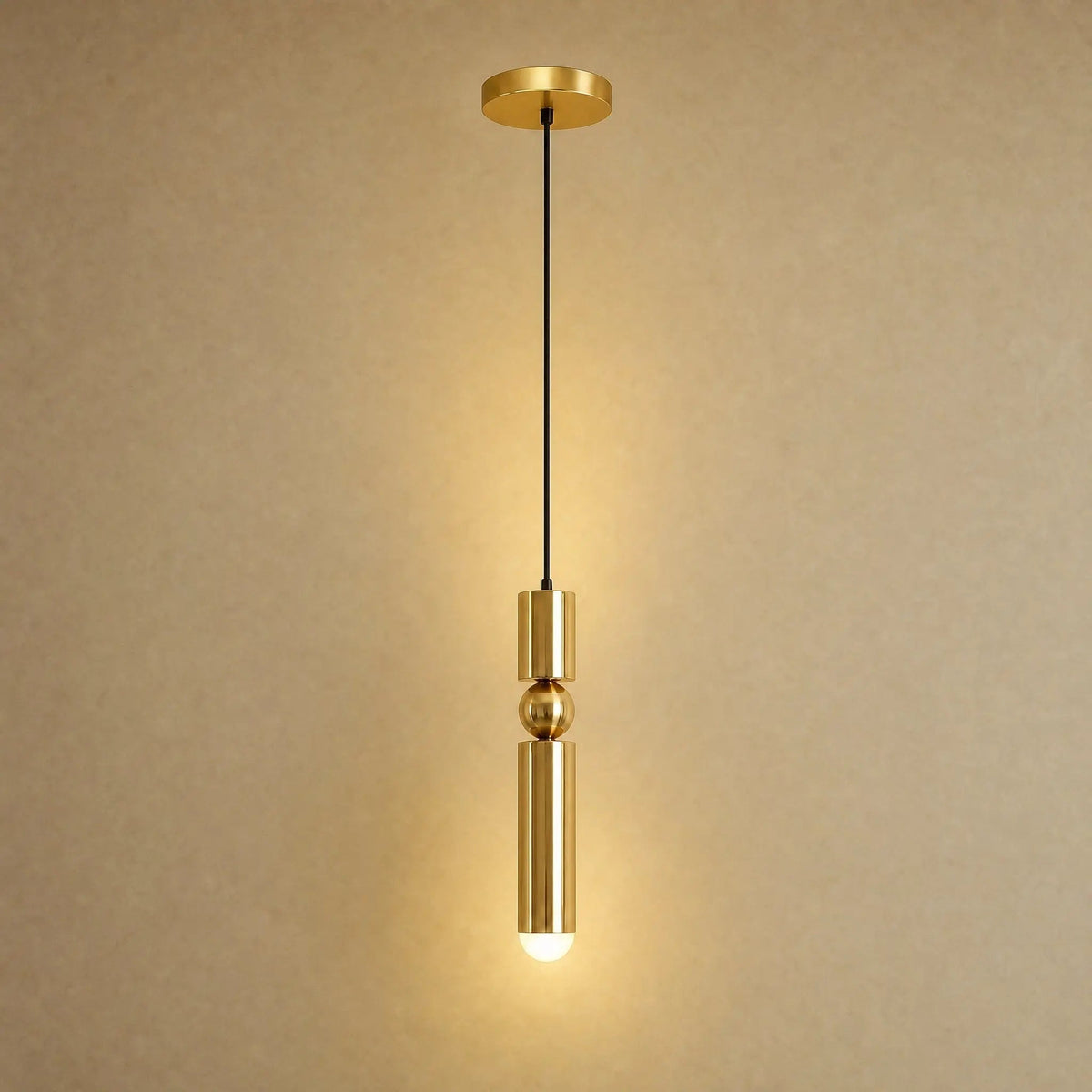 Gold pendant light with two cylindrical hanging elements and spherical details