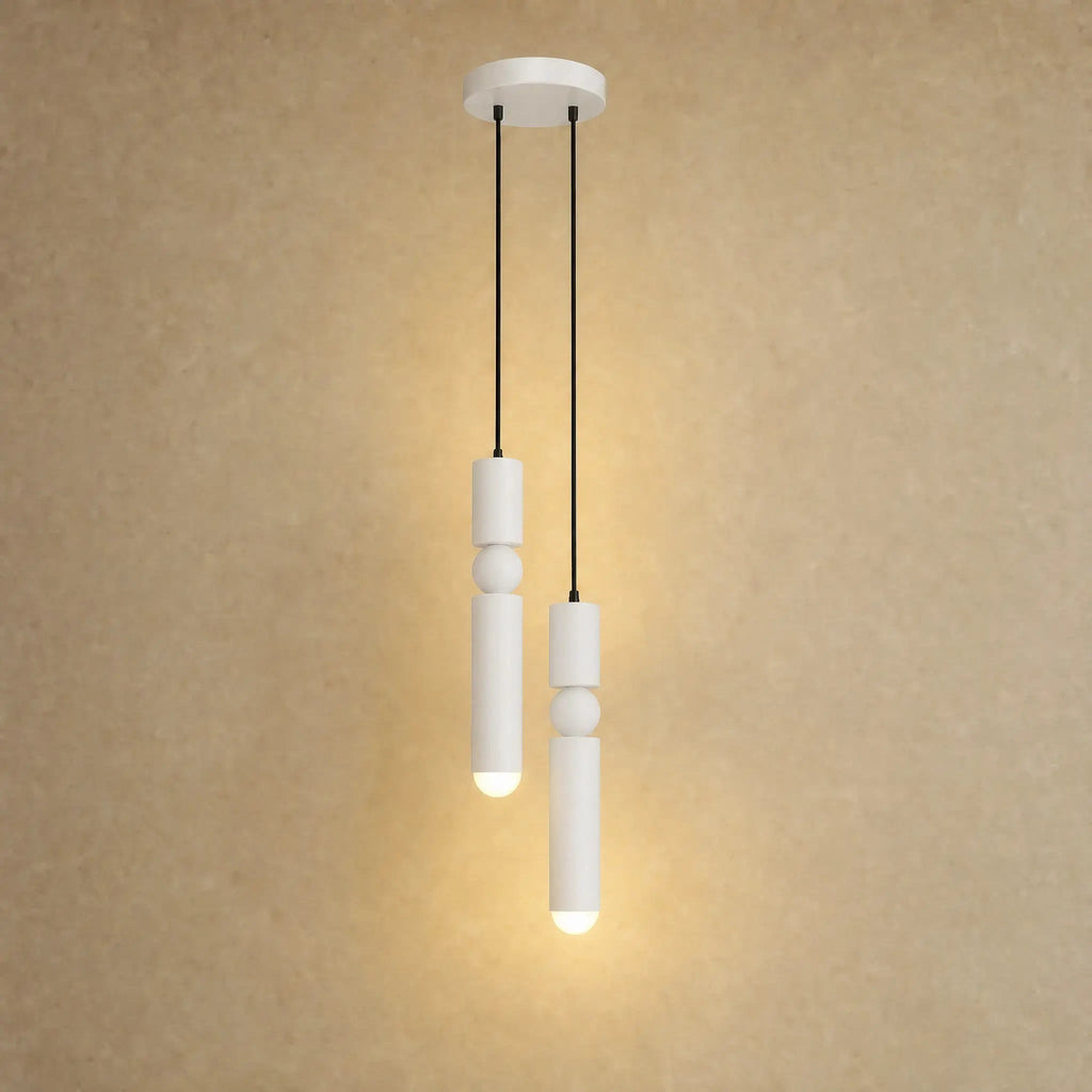 Gold pendant light with two cylindrical hanging elements and spherical details