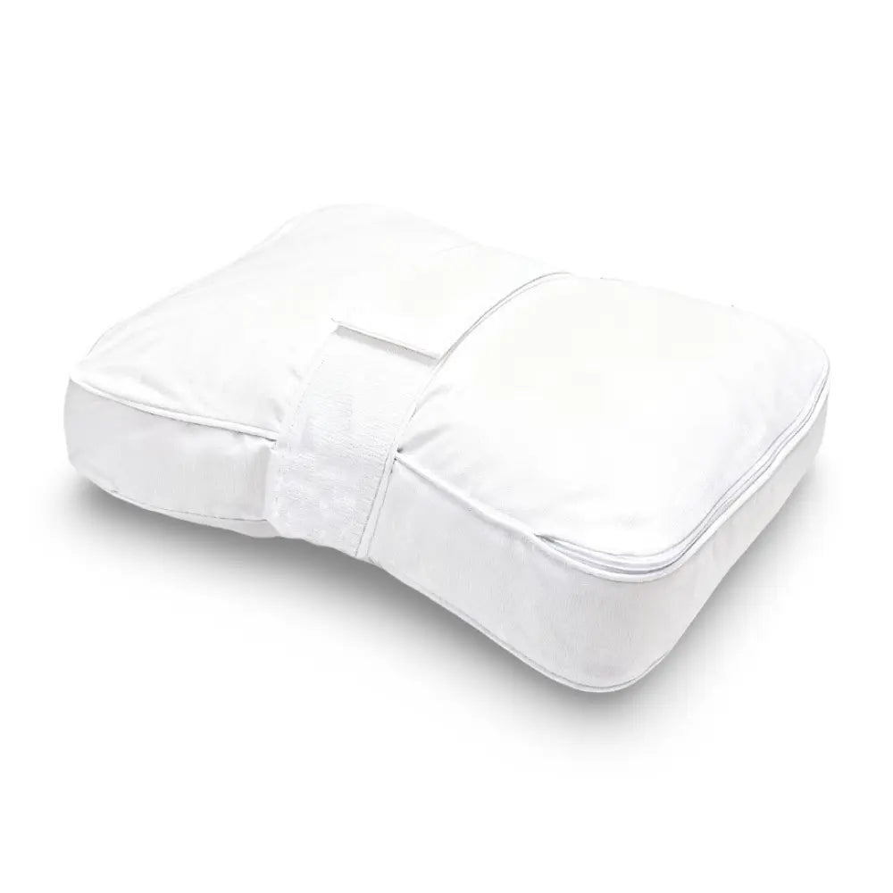 Contoured knee pillow with securing strap positioned between the legs
