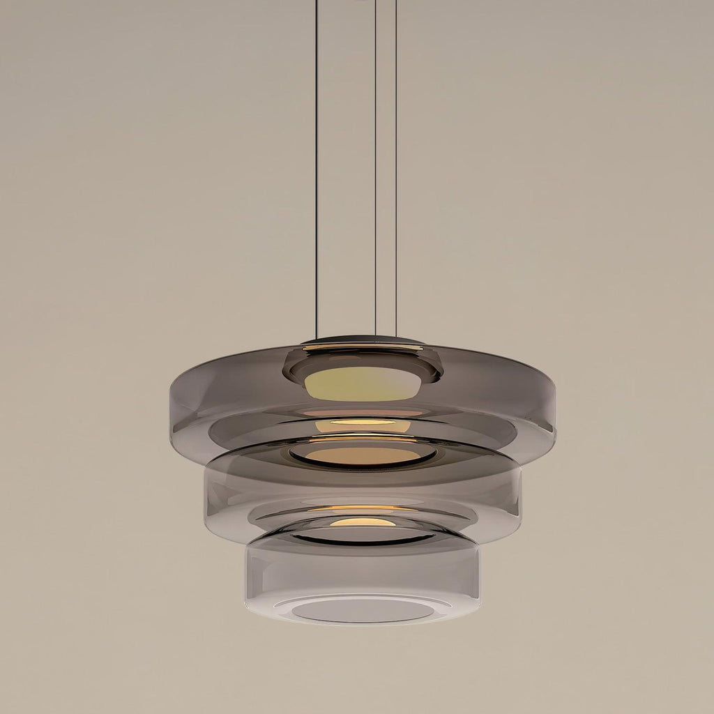 Rounded glass pendant light suspended from a black ceiling canopy