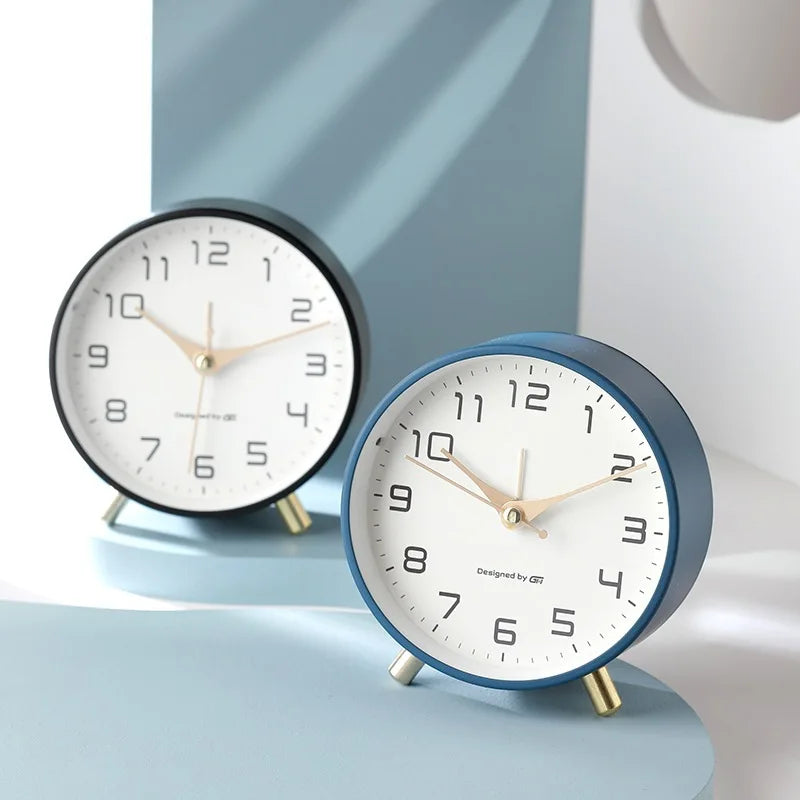 Scandinavian silent table clock with large numbered dial and twin-leg base
