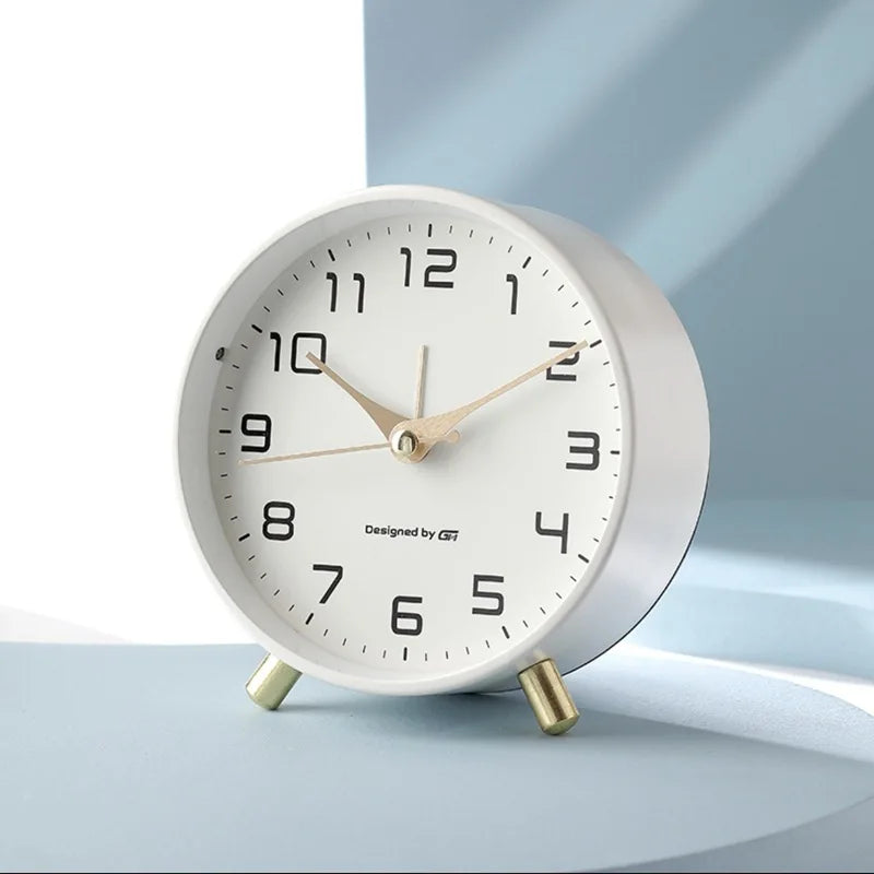 Scandinavian silent table clock with large numbered dial and twin-leg base