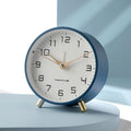 Scandinavian silent table clock with large numbered dial and twin-leg base