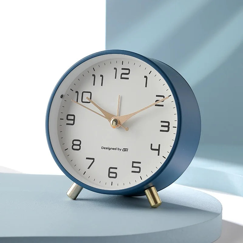 Scandinavian silent table clock with large numbered dial and twin-leg base