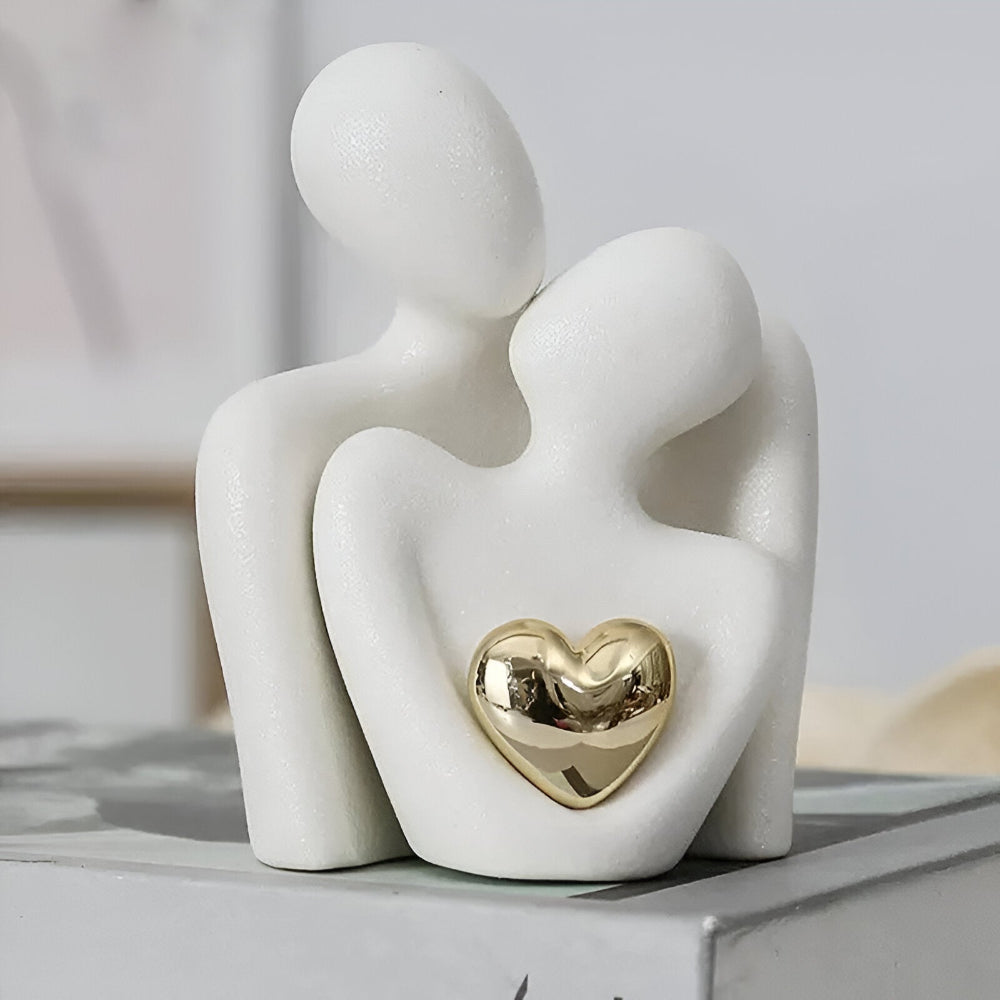 Abstract three-figure couple sculpture with a heart detail