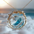 Gold-tone pendant necklace with blue ocean wave design and clear decorative stones