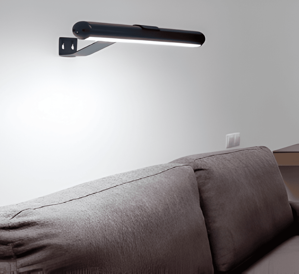 Cordless rotatable LED picture light mounted above framed artwork
