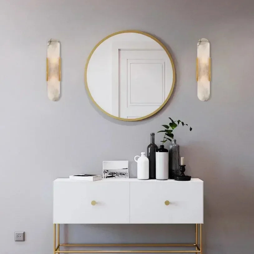 Vertical LED wall sconce with a light marble panel and contrasting side rails