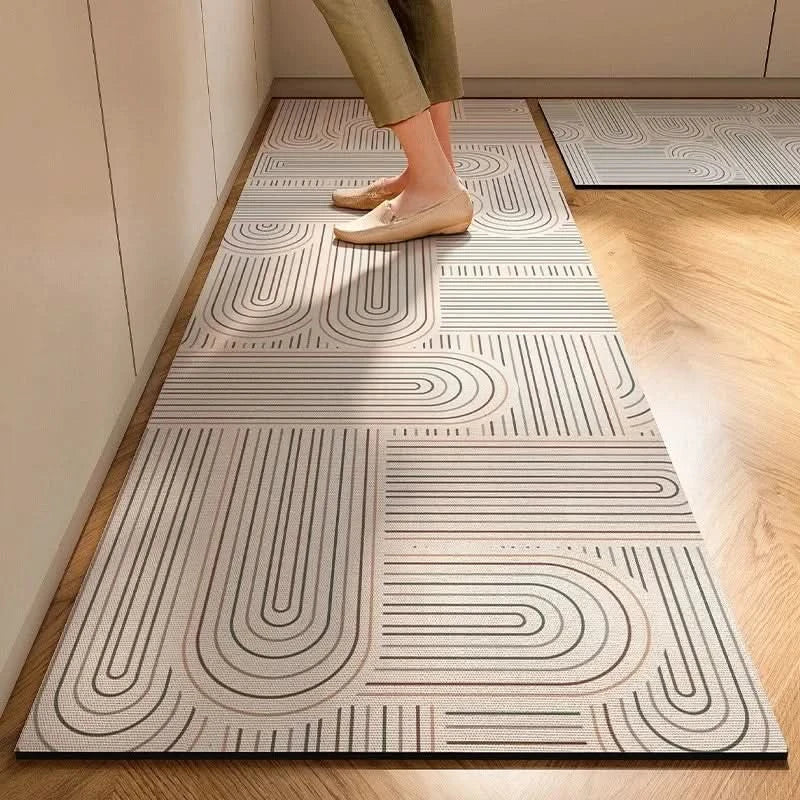 Gray striped cushioned non-slip kitchen mat on a wooden floor
