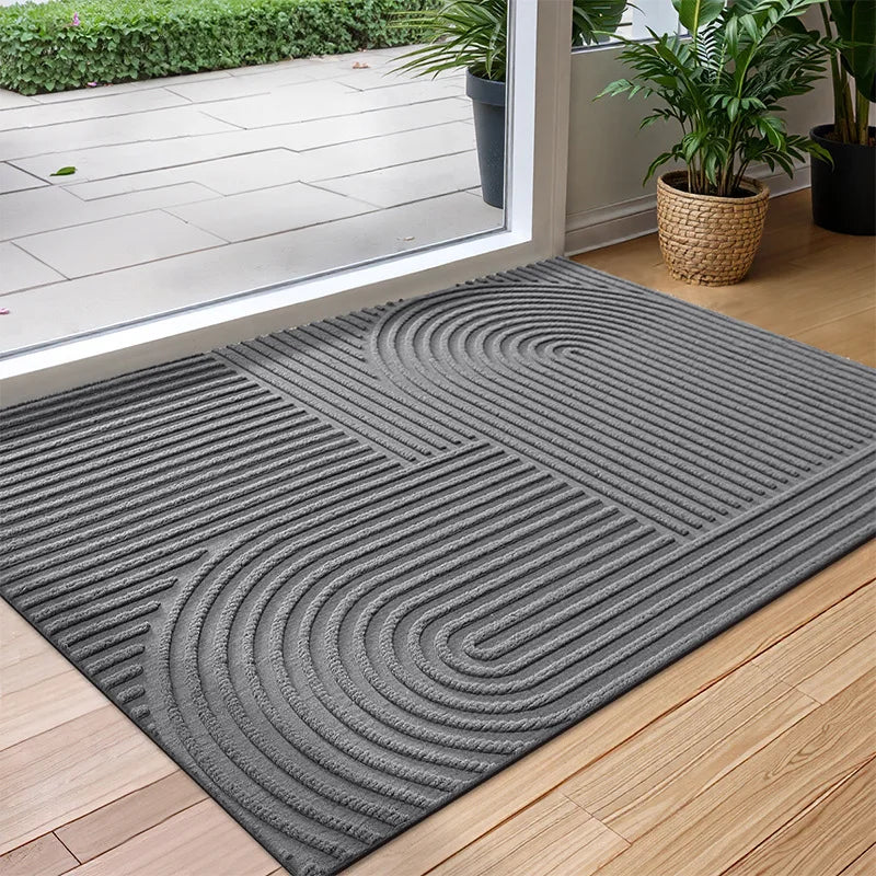 Rectangular textured geometric door mat at an entrance