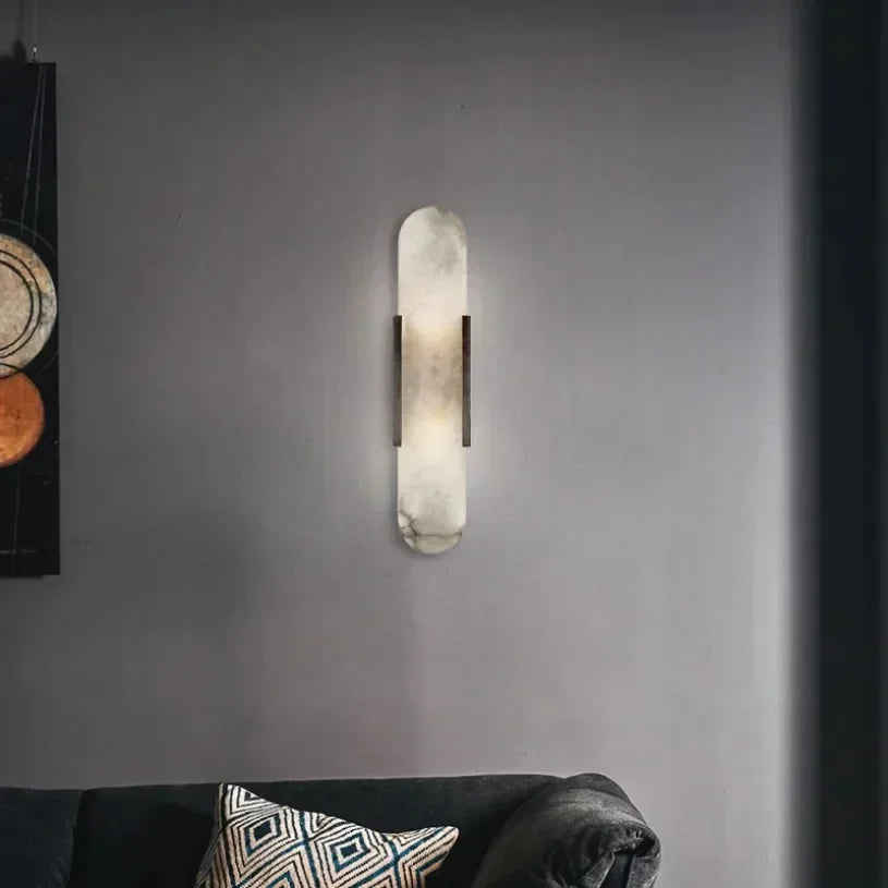 Vertical LED wall sconce with a light marble panel and contrasting side rails