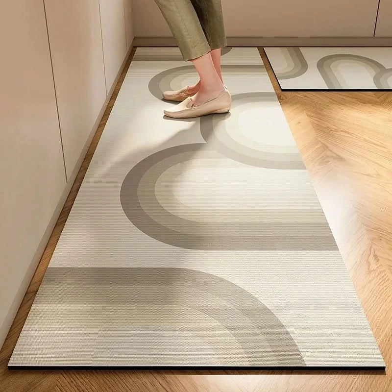 Gray striped cushioned non-slip kitchen mat on a wooden floor