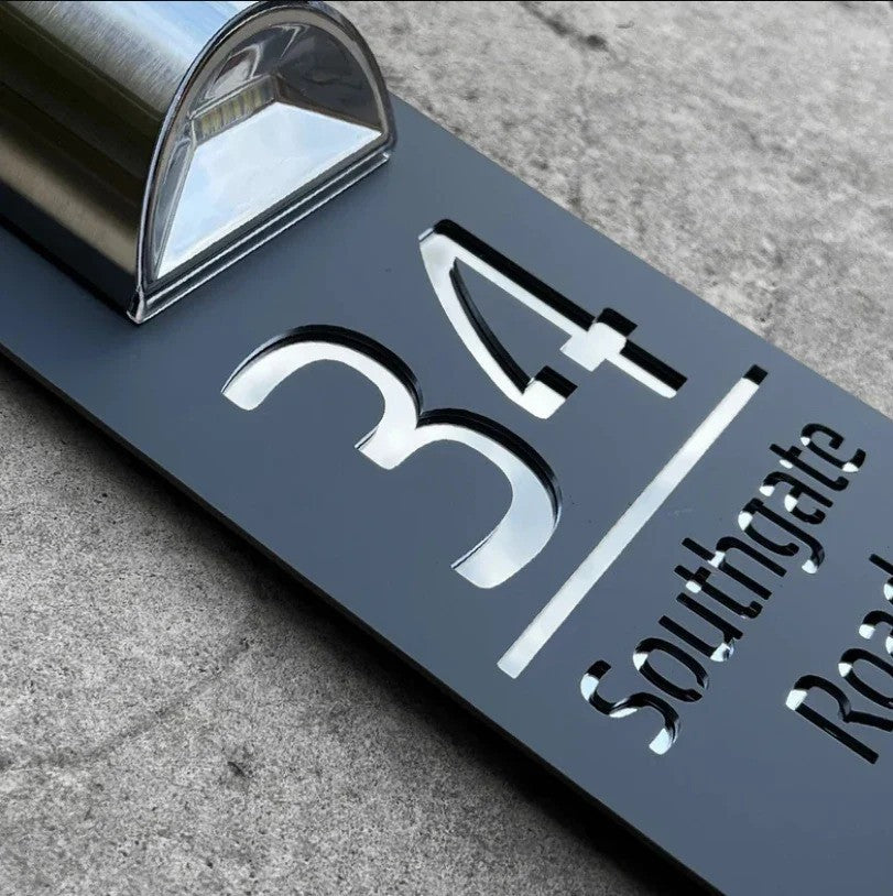 Personalised rectangular house number plaque with raised address lettering and curved upper panel