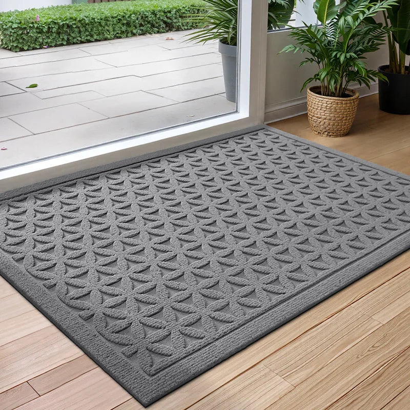 Rectangular textured geometric door mat at an entrance