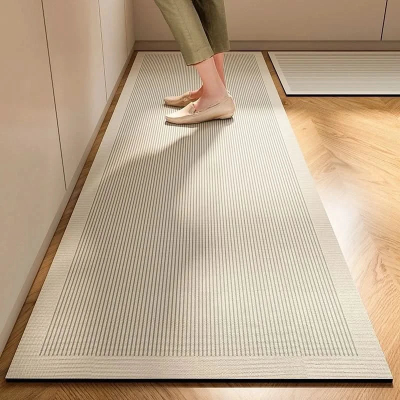 Gray striped cushioned non-slip kitchen mat on a wooden floor