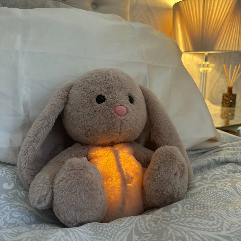 Gray bunny stuffed animal with long ears and glowing yellow belly