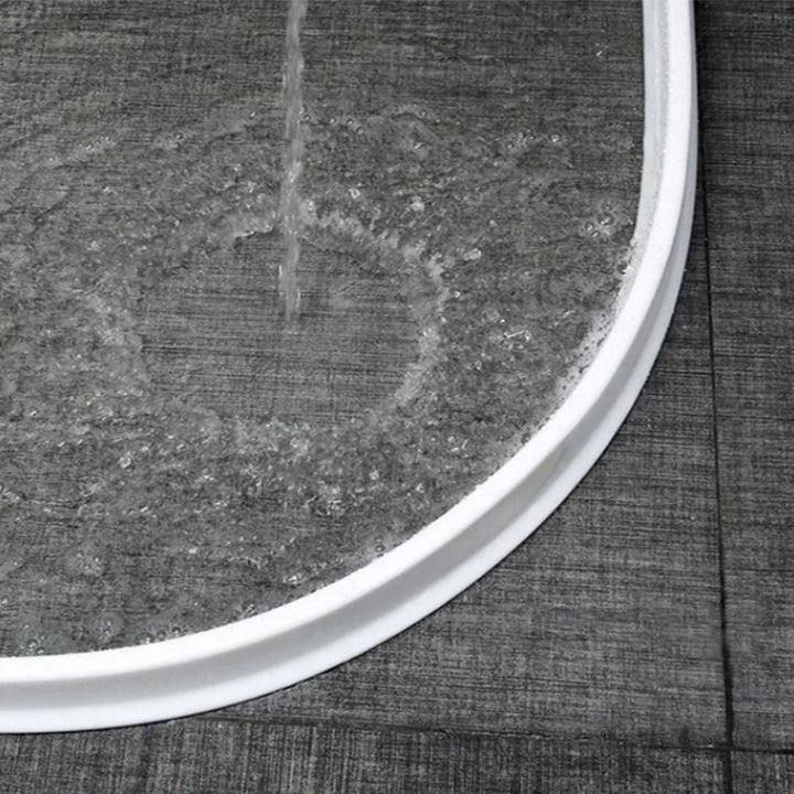 Shaped shower seal strip for bathroom leak prevention