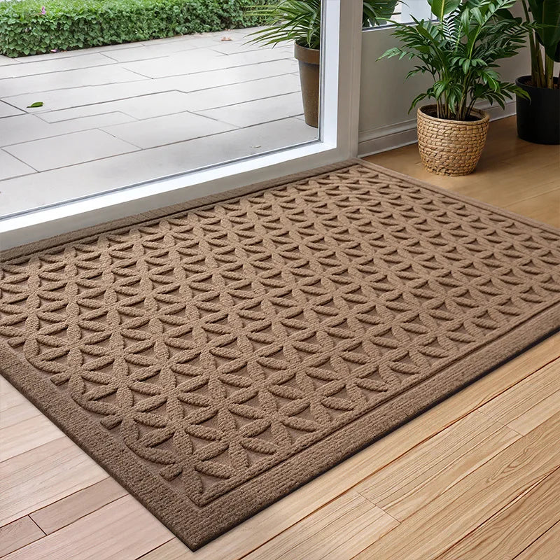 Rectangular textured geometric door mat at an entrance