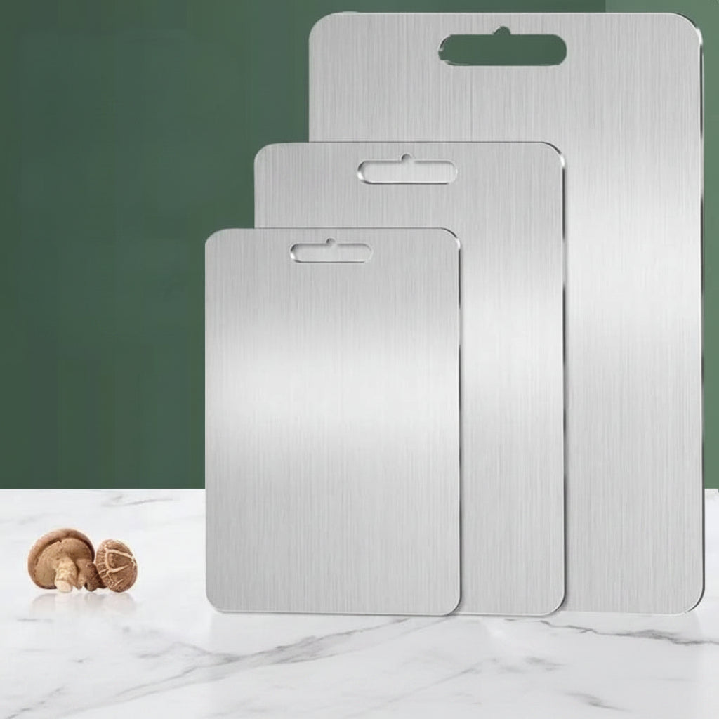 Set of three rectangular silver cutting boards with brushed finish and handle openings