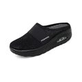 Closed-toe slip-on clog with perforated upper, broad strap and thick textured sole