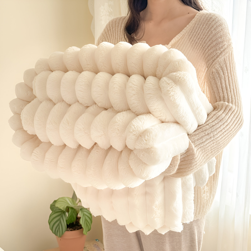 Plush ribbed fleece throw blanket draped over a chair