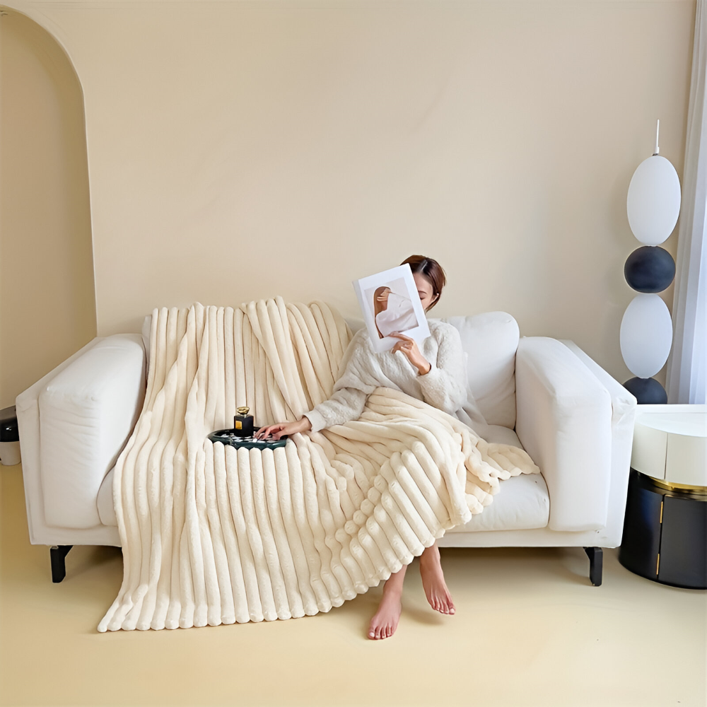 Plush ribbed fleece throw blanket draped over a chair
