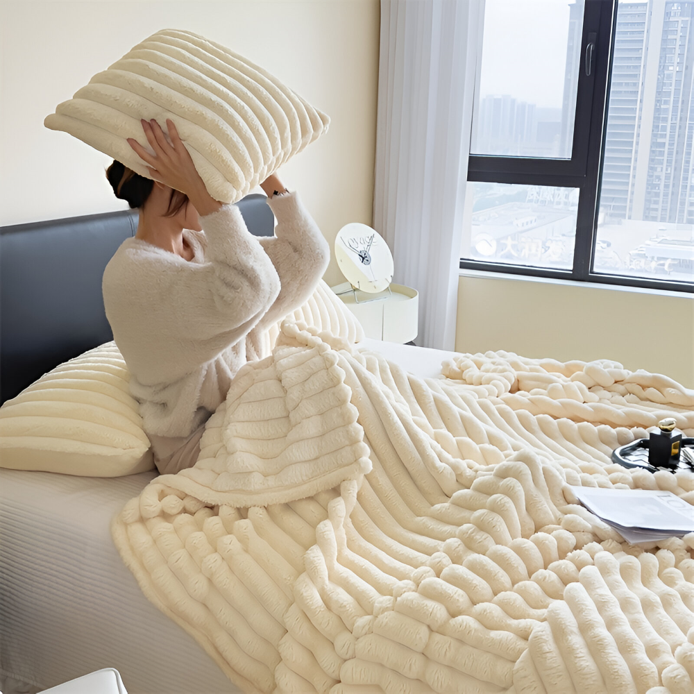 Plush ribbed fleece throw blanket draped over a chair