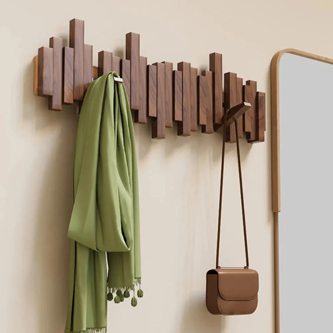 Wall-mounted ribbed coat rack with folding hooks