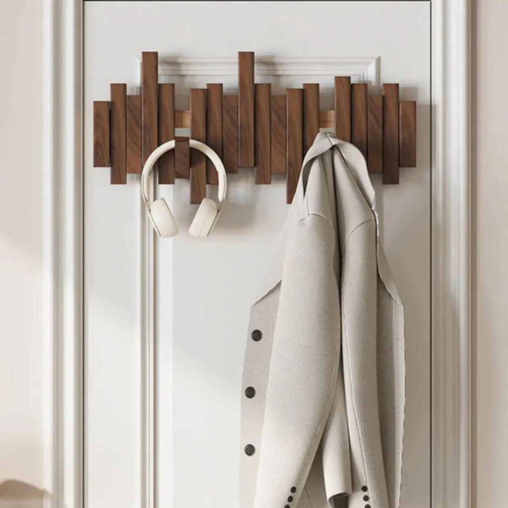 Wall-mounted ribbed coat rack with folding hooks