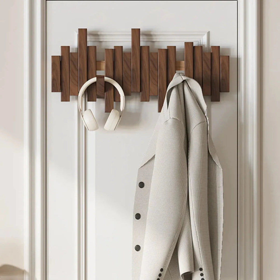 Wall-mounted ribbed coat rack with folding hooks