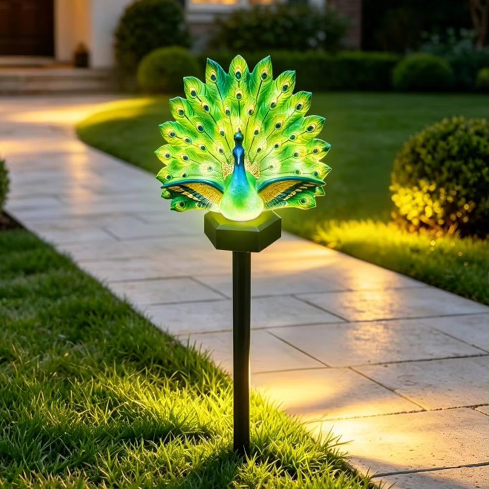 Green illuminated peacock solar garden light with feather display and ground stake