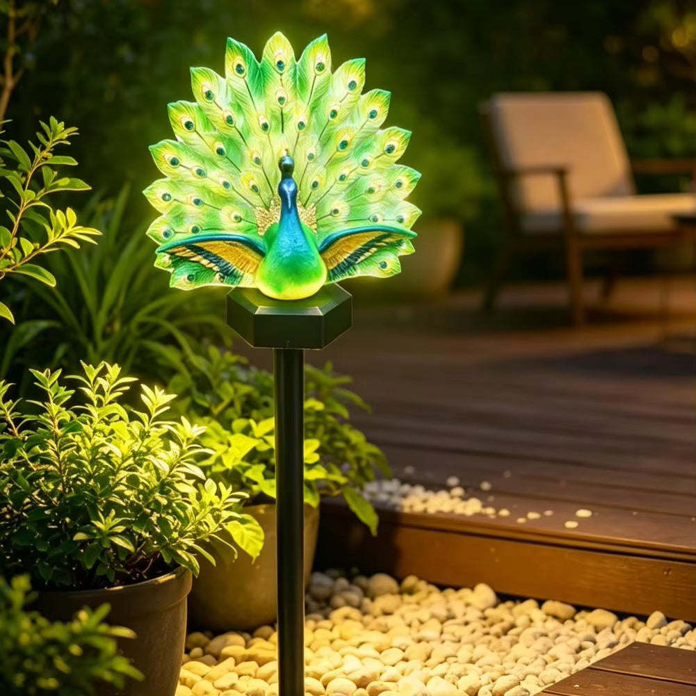 Green illuminated peacock solar garden light with feather display and ground stake