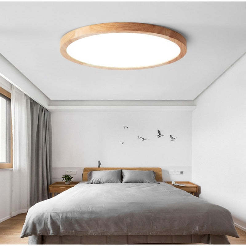 Round slim ceiling light with a natural wood-effect ring and white diffuser