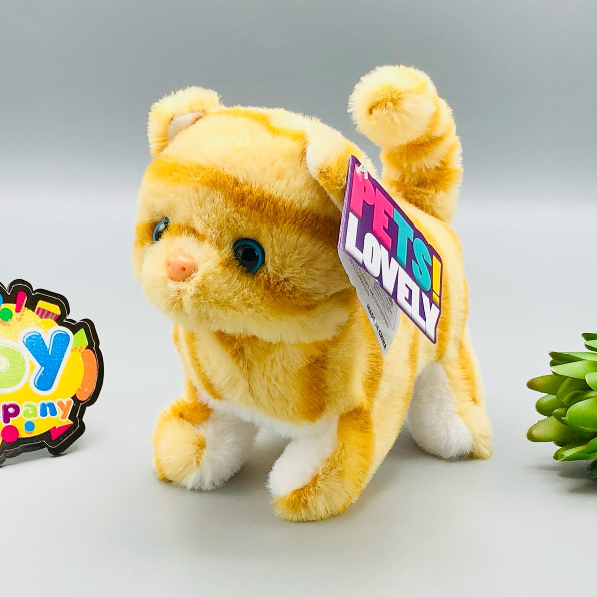 Walking plush cat toy with sound in white and orange striped designs