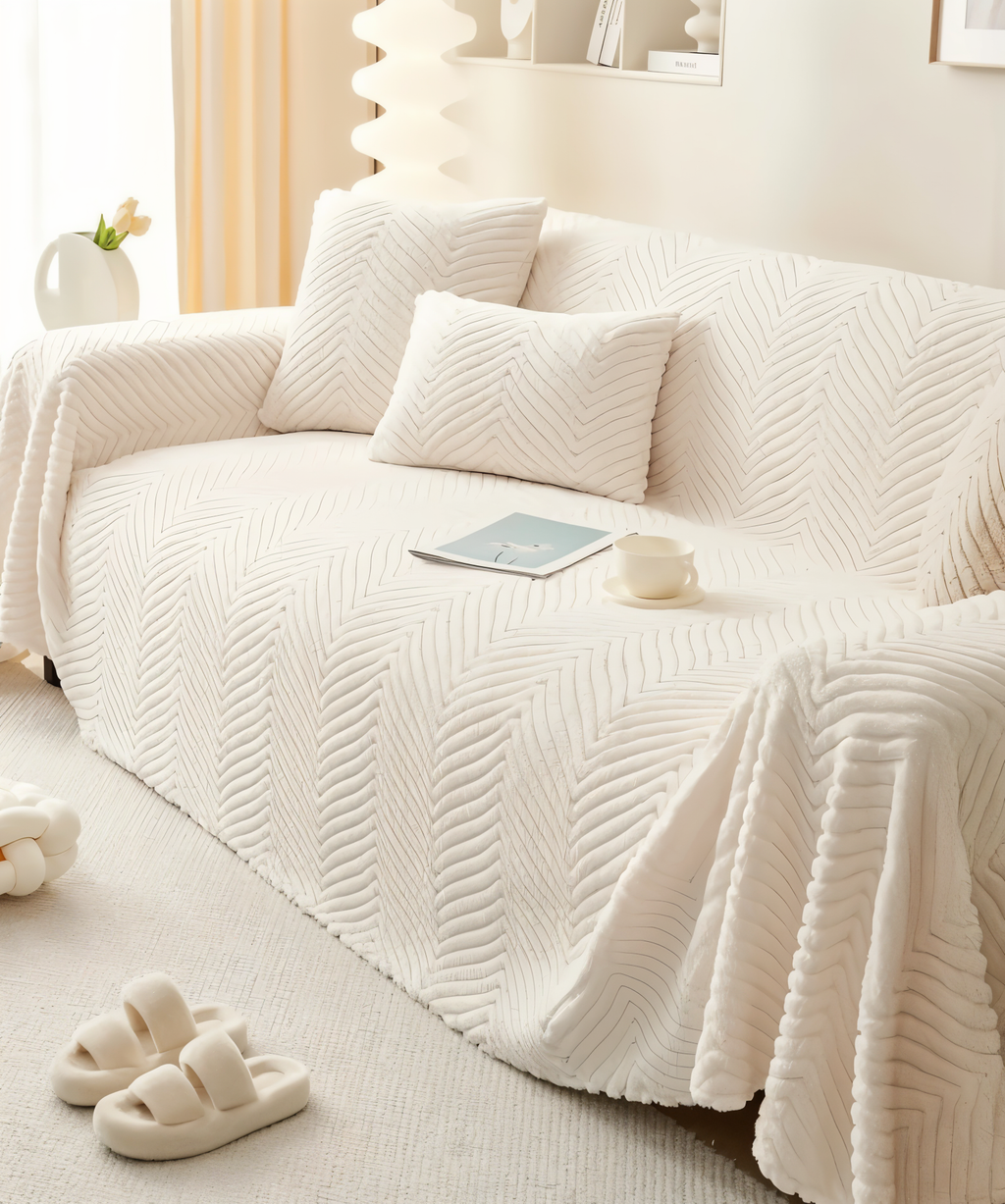 Geometric textured sofa cover draped over a living room sofa