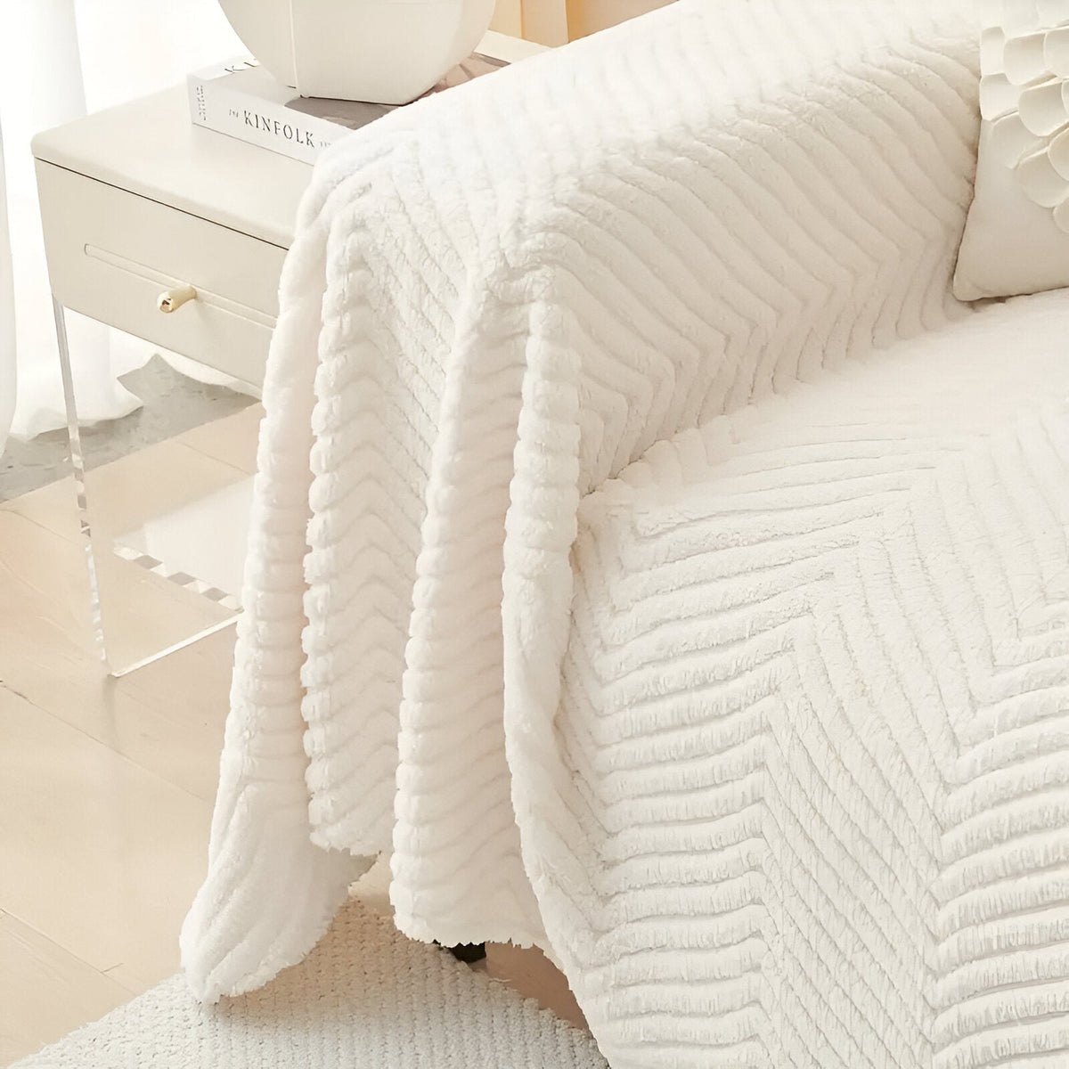 Geometric textured sofa cover draped over a living room sofa