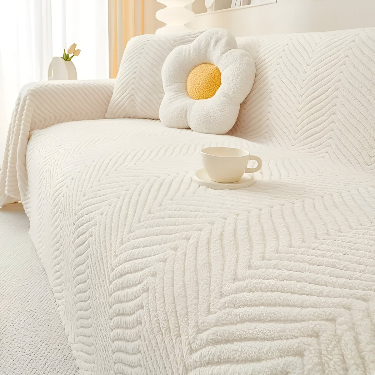 Geometric textured sofa cover draped over a living room sofa